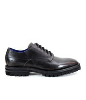 The Carter by Bed Stu is a black leather dress shoe with a rugged sole and lace-up design, crafted using Goodyear welt construction.