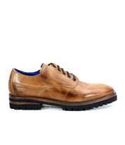 The Carter by Bed Stu is a men's oxford in an elegant brown, crafted from vegetable-tanned leather. This lace-up shoe features a durable black treaded sole and boasts Goodyear welt construction, showcased beautifully in the side view.