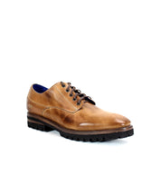 The Carter from Bed Stu is a brown leather dress shoe featuring black laces and a durable sole with Goodyear welt construction for enhanced longevity.
