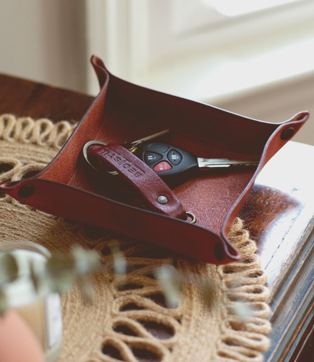 A leather tray with a key holder on top by Bed Stu.