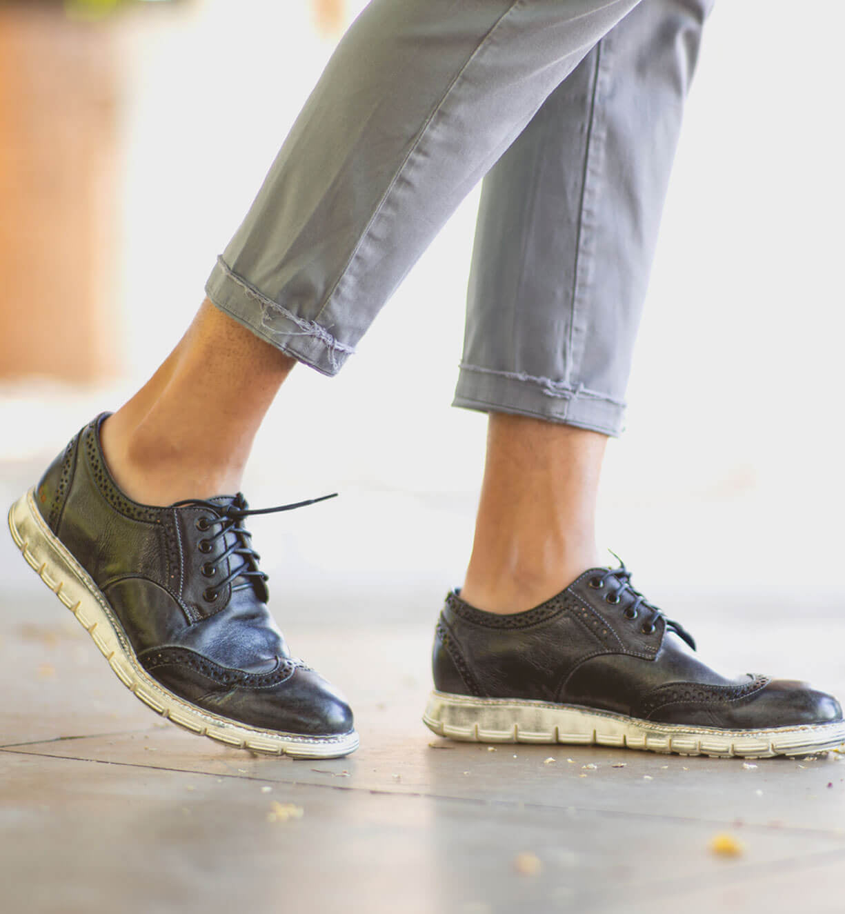A person wearing a pair of black Bed Stu Cayuga II shoes.