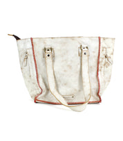 A white Bed Stu Celindra LTC tote bag with red accents, featuring two handles, a brand label, and visible signs of wear. This spacious zip-top tote also includes a secret pocket for added convenience.