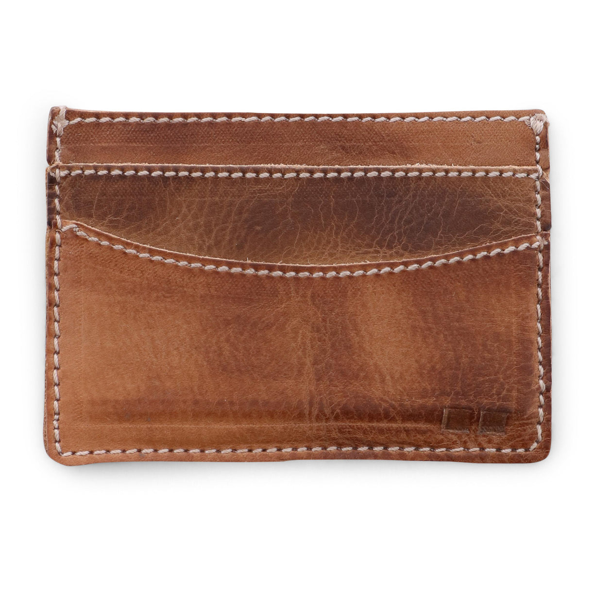 A Chuck card holder by Bed Stu, made of tan leather, on a white background.