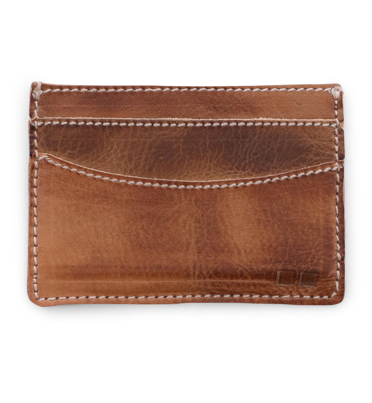 A Chuck card holder by Bed Stu, made of tan leather, on a white background.