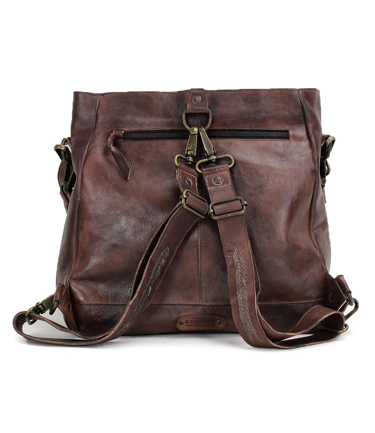A brown leather Cirdan backpack with straps and buckles by Bed Stu.
