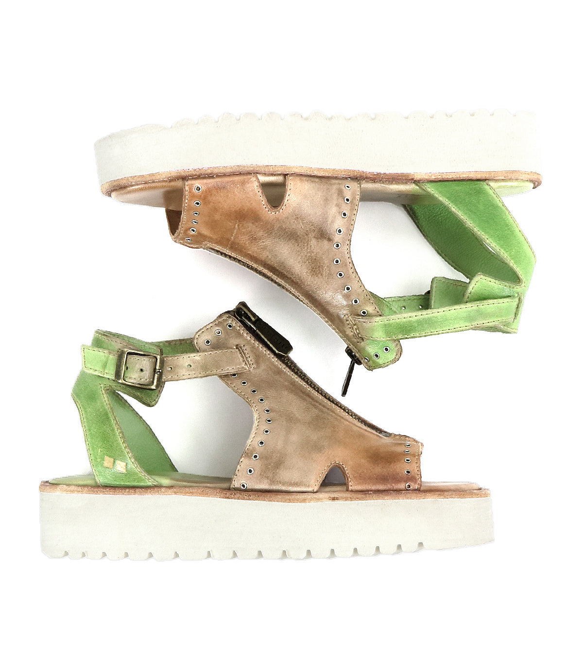 Two mismatched Bed Stu Clancy sandals with rugged soles are arranged vertically. One is brown, the other green, each featuring an ankle strap, zipper, and metal grommet details for flair.