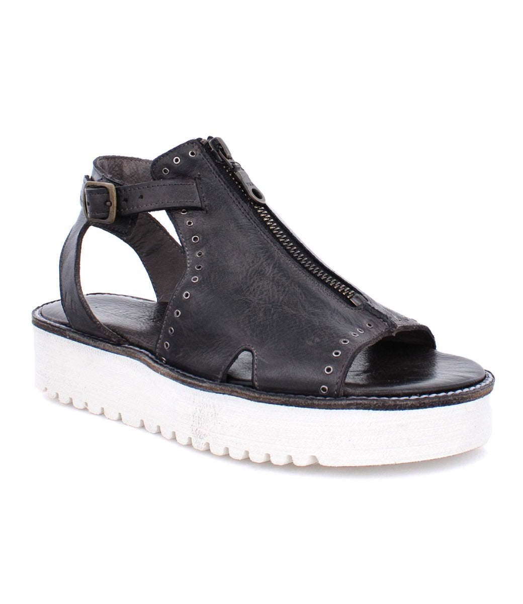 A Clancy sandal by Bed Stu, made of black pure leather with a white sole.
