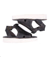 A pair of Clancy sandals by Bed Stu, made of black leather with a white sole.