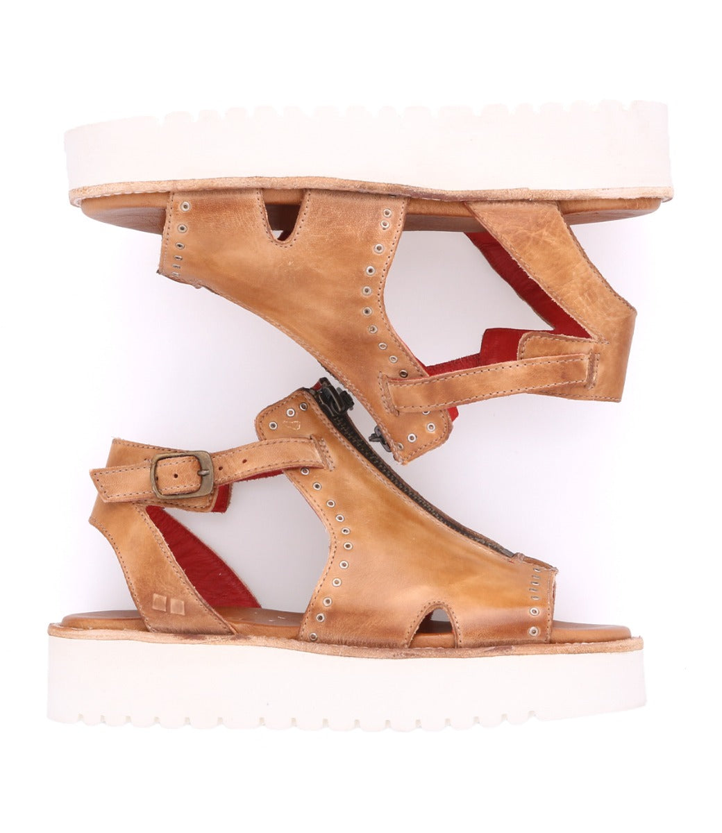 A pair of Clancy sandals by Bed Stu, made of tan leather with a white sole.