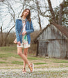 Woman wearing Clancy sandals by Bed Stu, made of tan pure leather with a white sole.