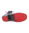 A pair of Clarisse boots with a red sole and a black sole by Bed Stu.