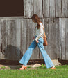A woman wearing Clavel mule with a wooden heel from Bed Stu.