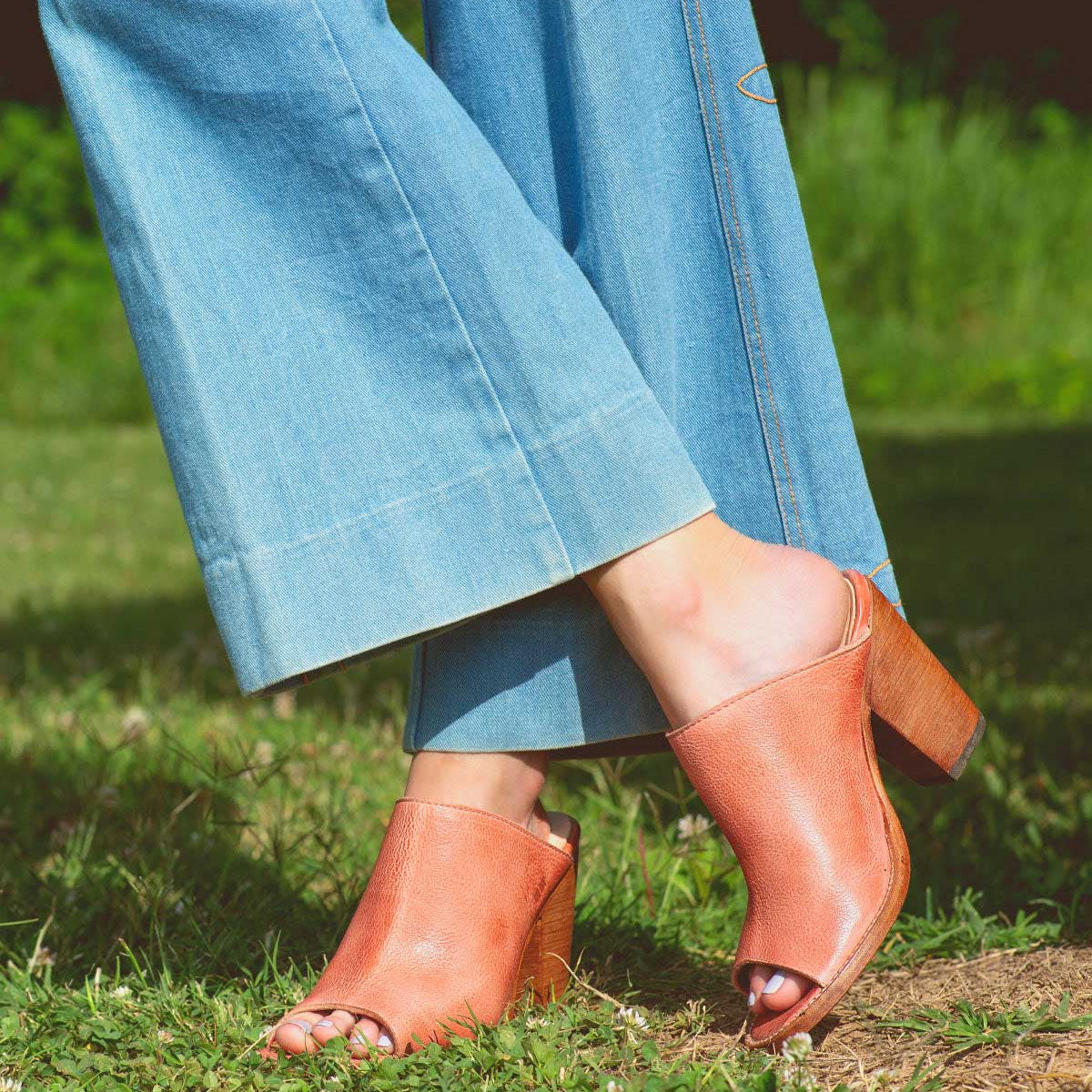 A woman wearing Clavel mule with a wooden heel from Bed Stu.