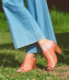 A woman wearing Clavel mule with a wooden heel from Bed Stu.