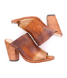 A pair of Clavel brown leather mules with a wooden heel by Bed Stu.