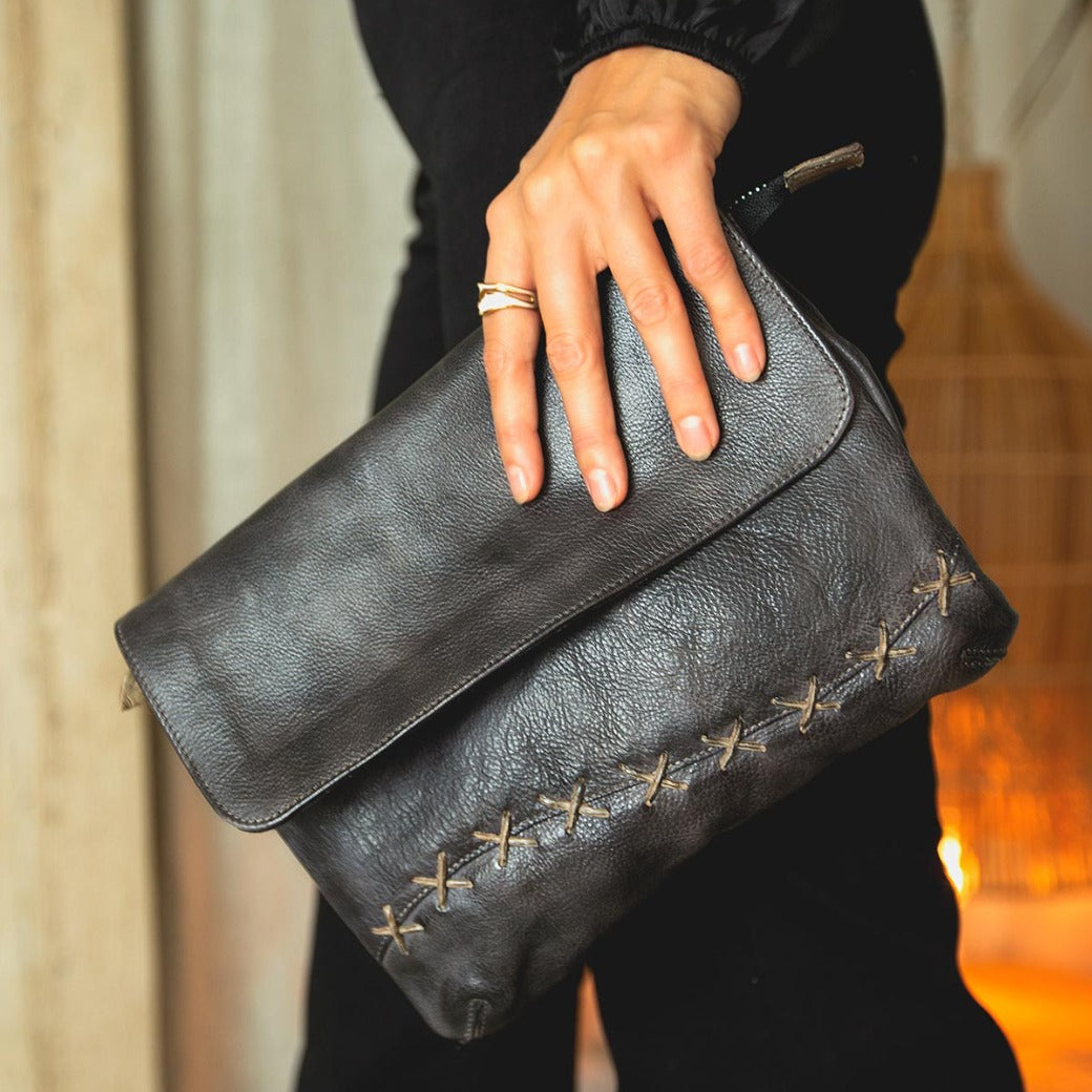 Woman holding a black Cleo Bag by Bed Stu.