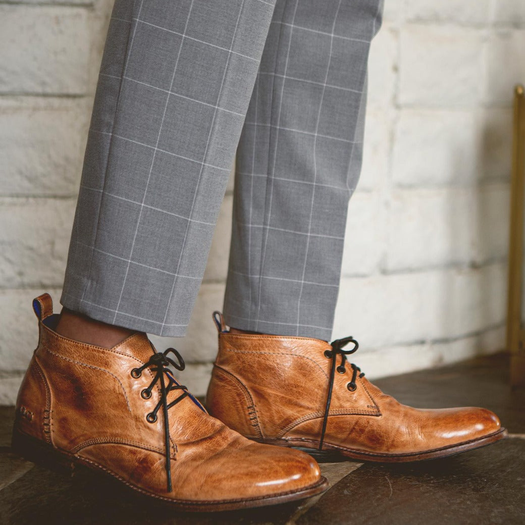 A man wearing a pair of Bed Stu Clyde brown lace up shoes.