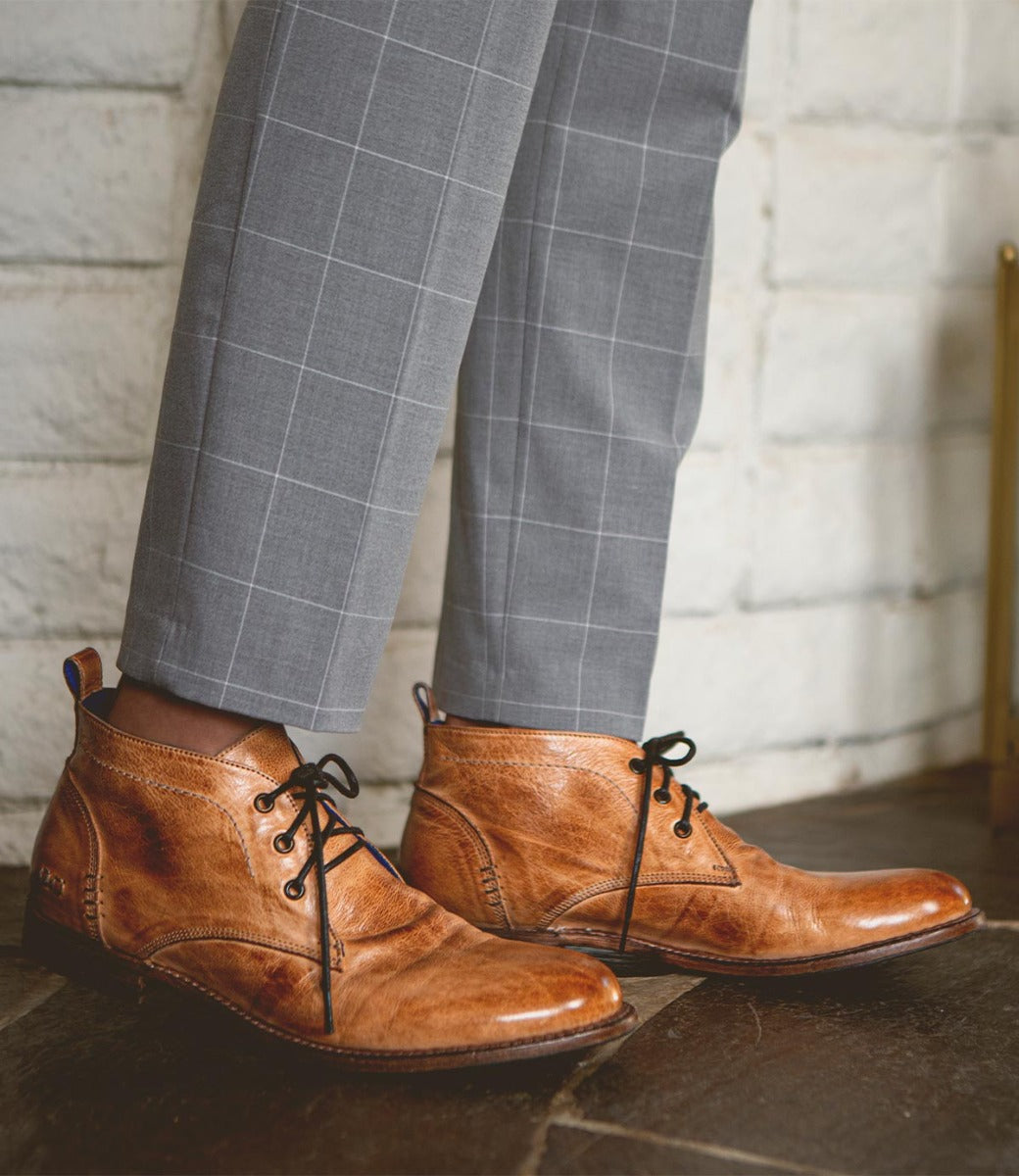 A man wearing a pair of Bed Stu Clyde brown lace up shoes.