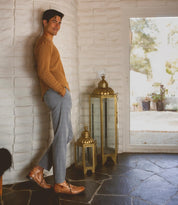 A man leaning against a wall with a Bed Stu Clyde lantern.