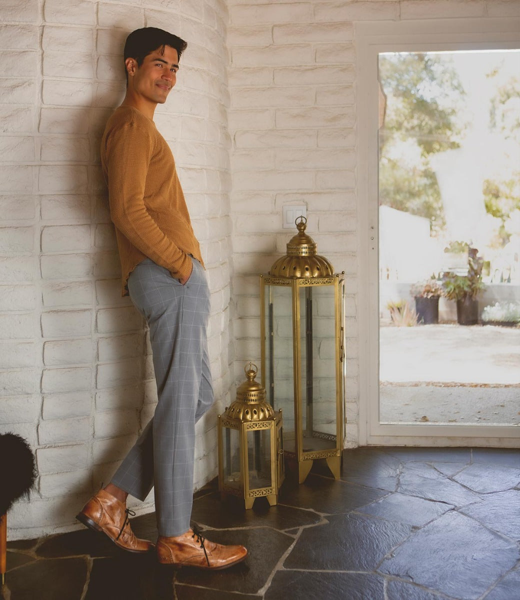 A man leaning against a wall with a Bed Stu Clyde lantern.