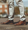 A man's feet standing on a Clyde manhole from the brand Bed Stu.