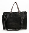 A multifunctional Bed Stu Commuter tote bag in black leather, with a shoulder strap for laptops up to 15 inches.