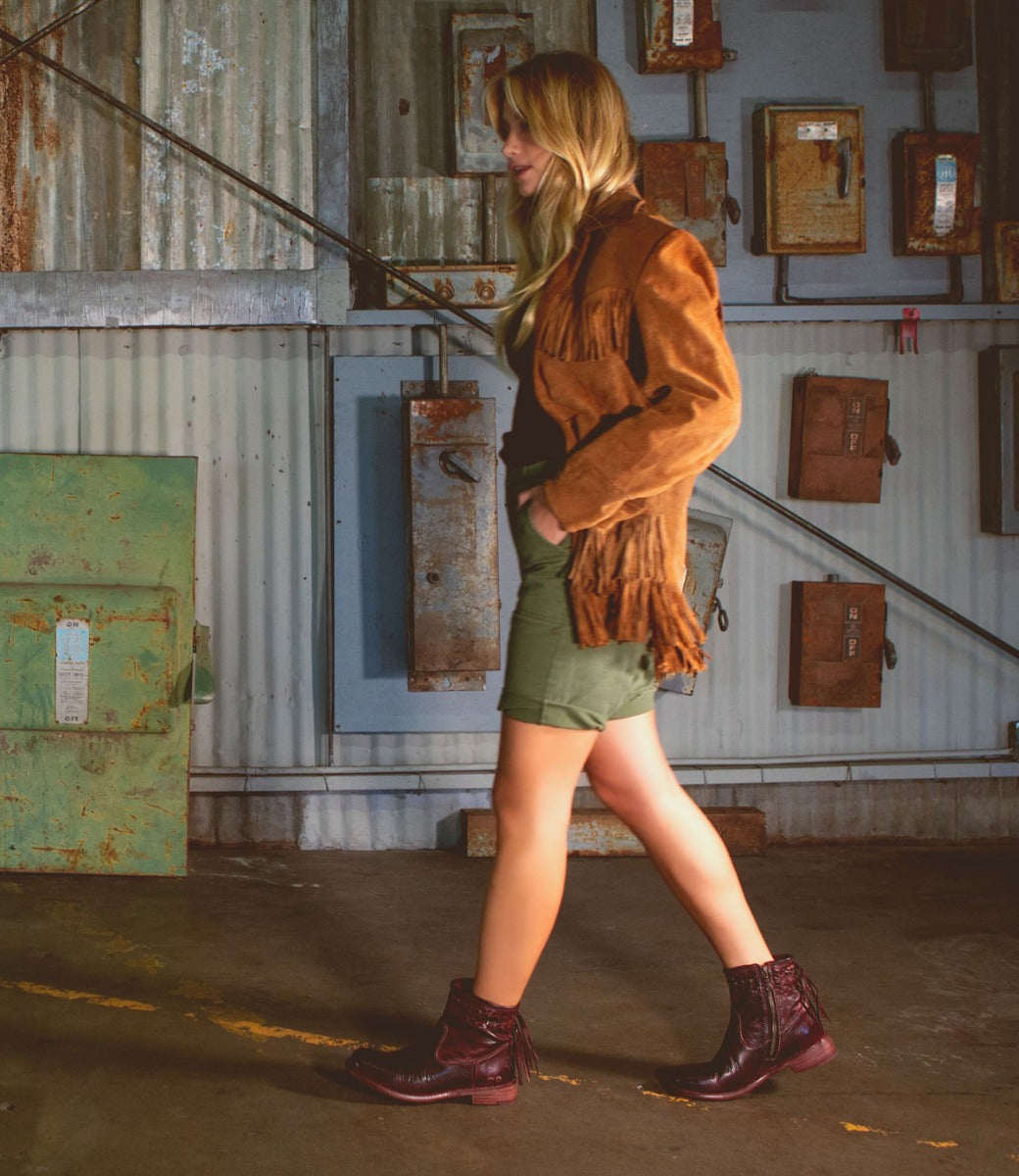 A woman in Bed Stu Craven burgundy leather boots.