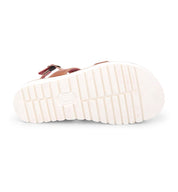 A pair of Bed Stu sandals with white straps and a white sole.