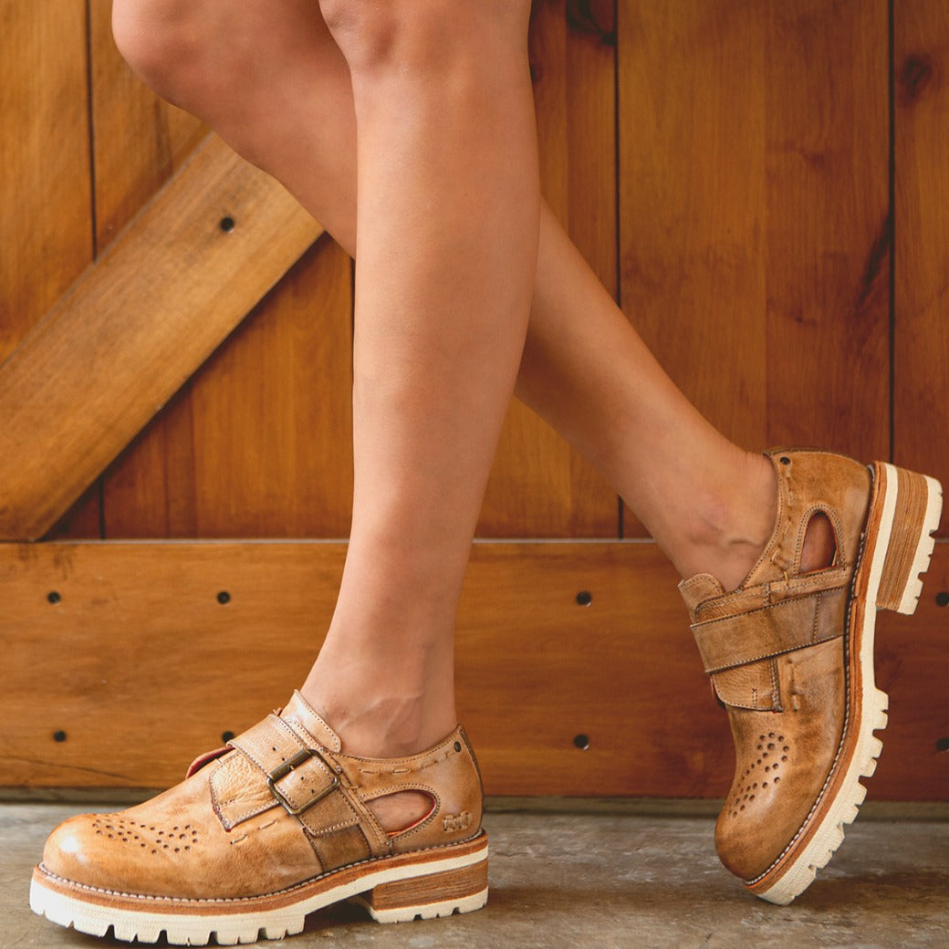 A woman wearing Bed Stu Dagny women’s tan leather shoes.