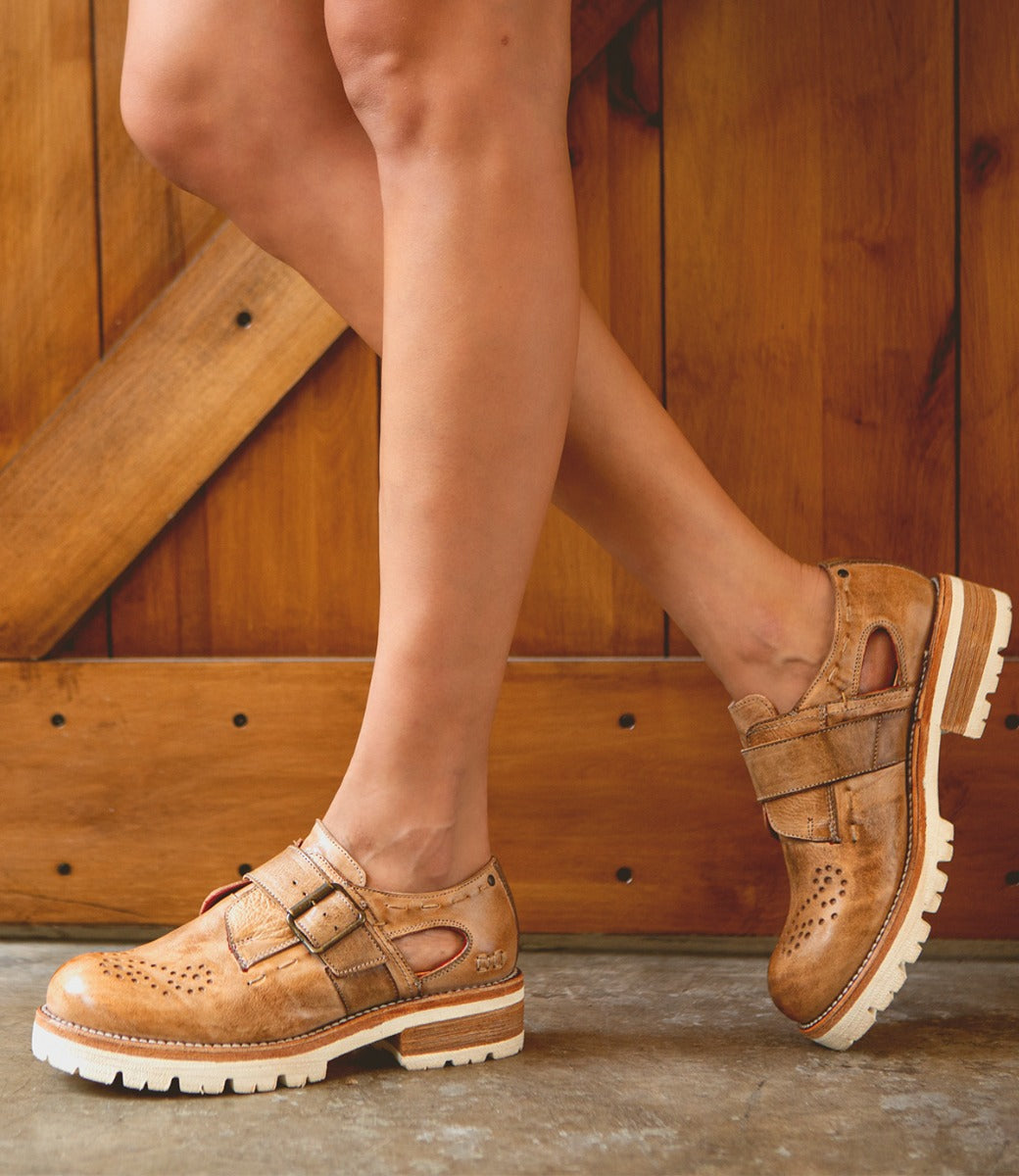 A woman wearing Bed Stu Dagny women’s tan leather shoes.