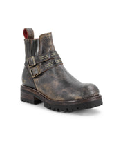 The Bed Stu Daring is a single rugged, distressed leather ankle boot featuring a stacked heel, adjustable buckle straps, elastic panels, pull tab, and thick treaded sole.