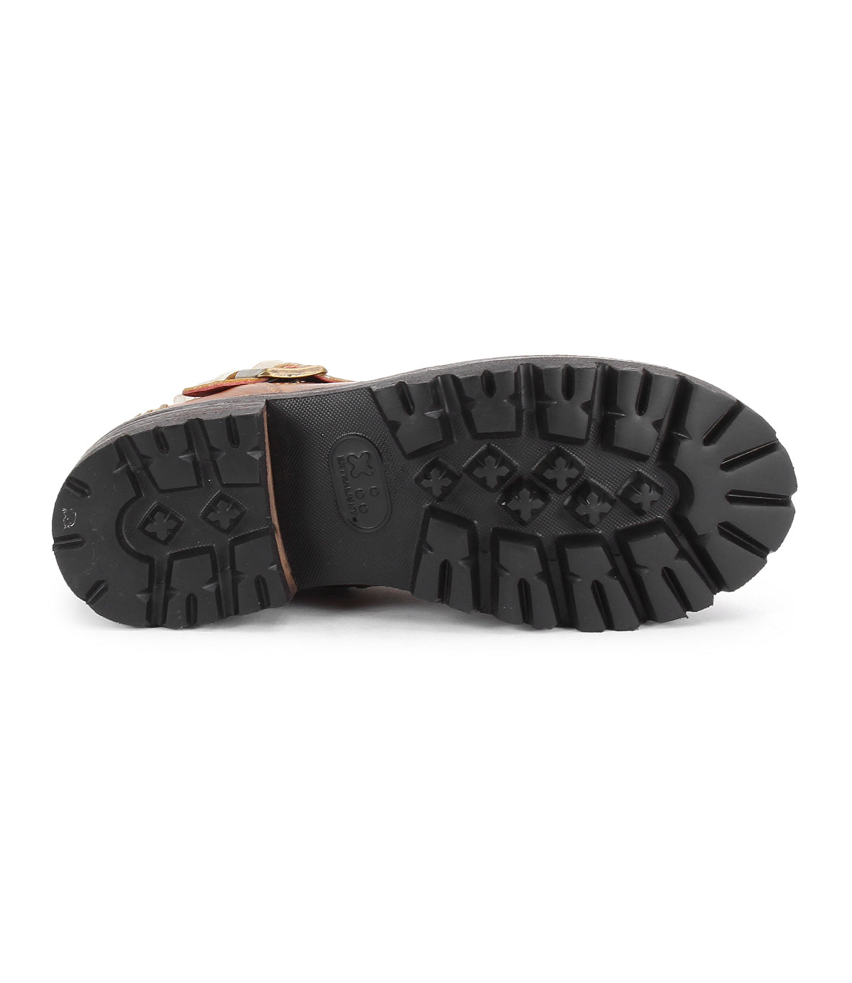 Close-up of the Bed Stu Daring boot's black rubber sole with deep lugs and cross-shaped treads, plus a glimpse of the brown upper, highlighting its rugged style.