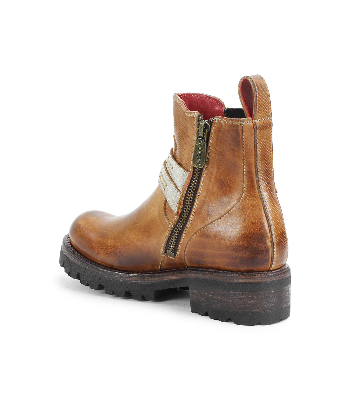 The Bed Stu Daring boots feature brown leather, a chunky black sole, decorative side zipper, beige strap detail, and red inner lining for a rugged style—shown from the back left angle.
