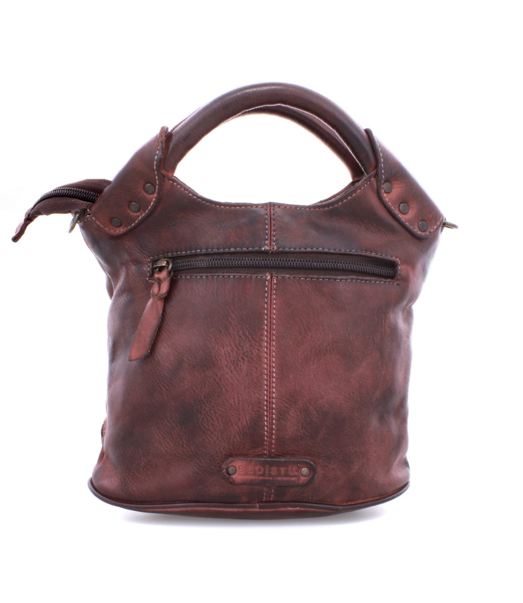 A brown leather Delilah handbag by Bed Stu with two handles and a zipper.