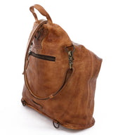 A brown leather Delta bag with straps and handles by Bed Stu.
