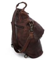 A brown leather Delta backpack with straps and a shoulder strap from Bed Stu.