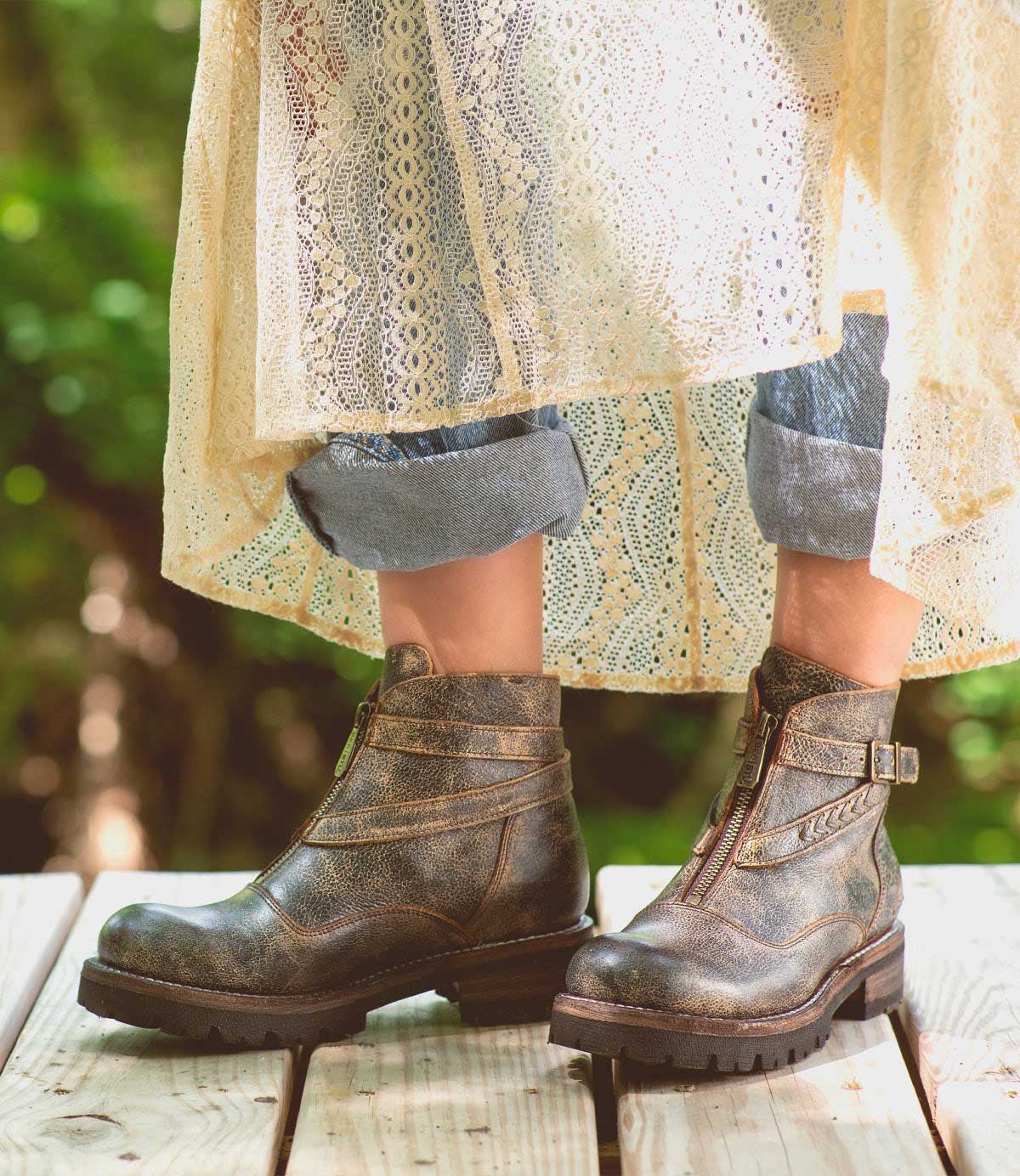 A woman wearing Dessa black leather boots from Bed Stu.