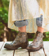 A woman wearing Dessa black leather boots from Bed Stu.