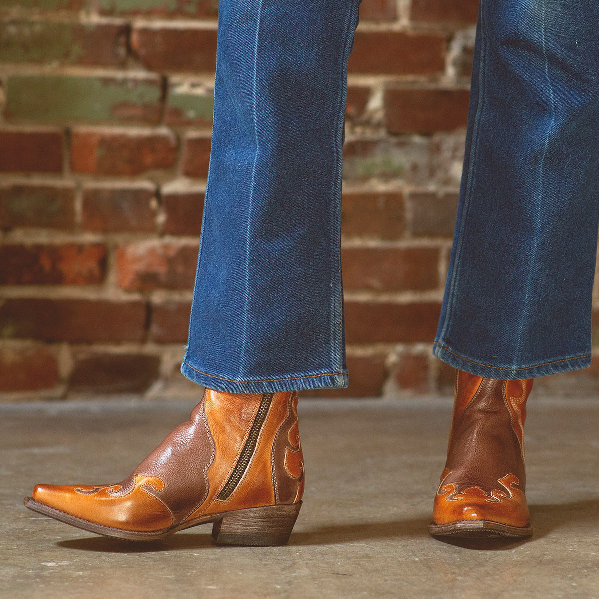 A woman exuding rustic charm in her Bed Stu Deuce jeans and leather cowboy boots.