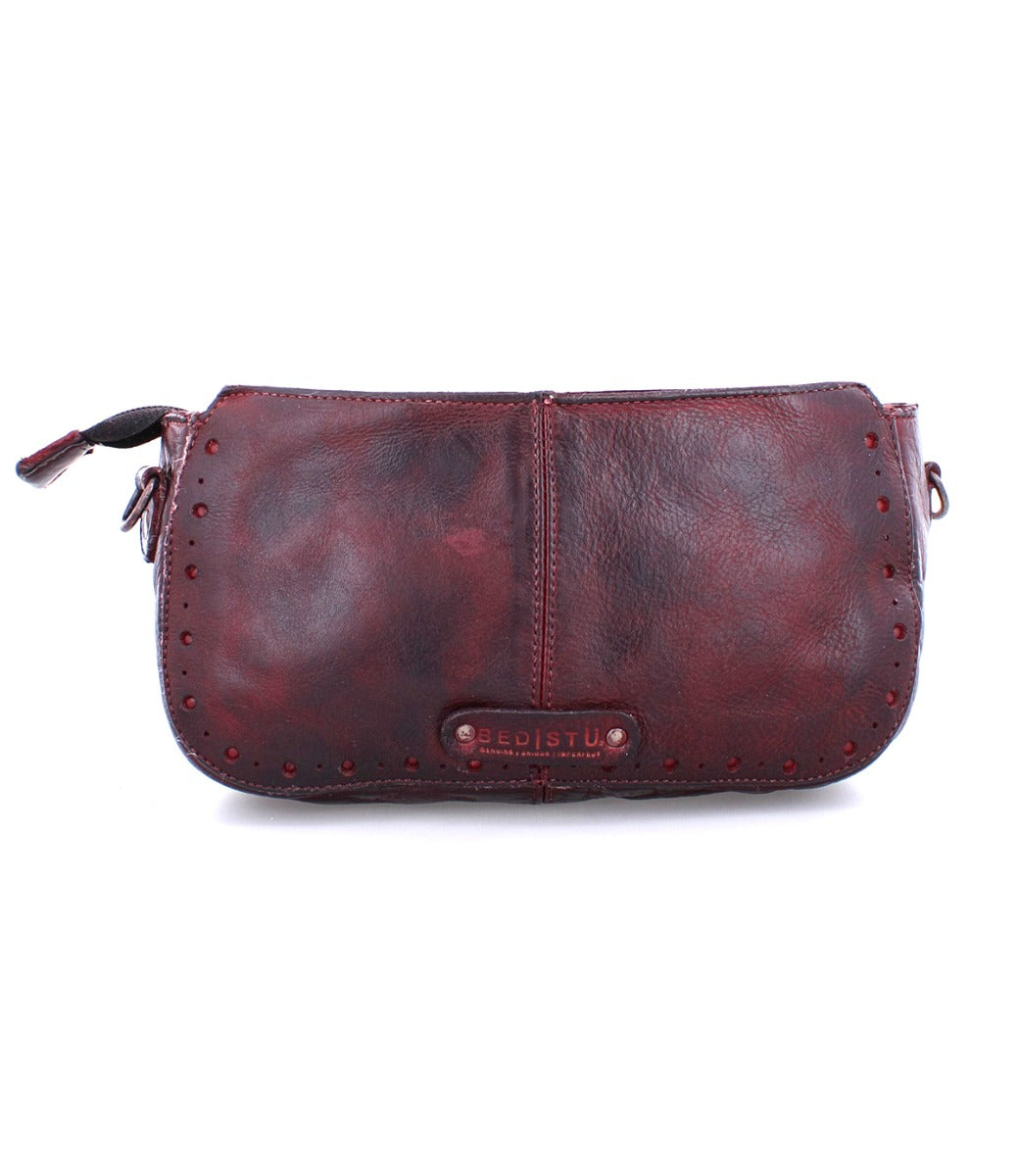 A Dolon burgundy leather purse by Bed Stu with a zipper.