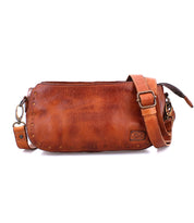 A brown leather Dolon crossbody bag with a Bed Stu strap.
