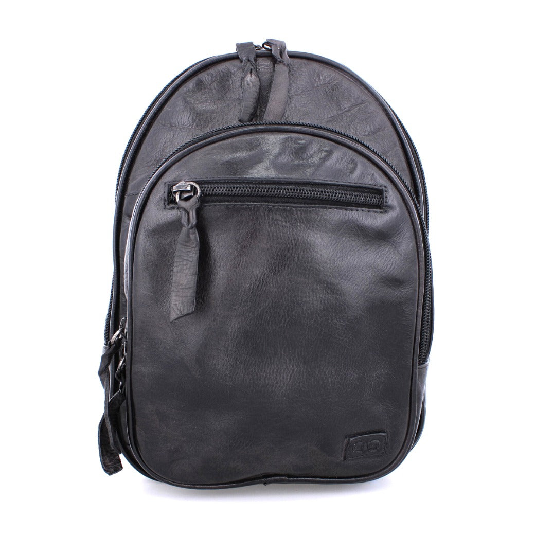 A Dominique black leather backpack on a white background by Bed Stu.