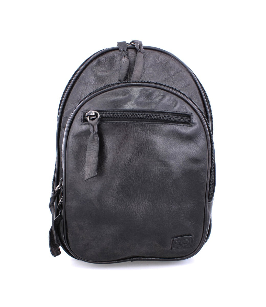 A Dominique black leather backpack on a white background by Bed Stu.