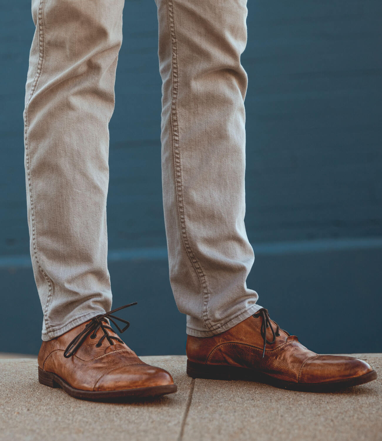 A man wearing a pair of brown Bed Stu Donatello shoes.