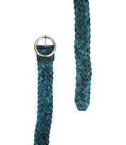 The Dreamweaver belt by Bed Stu, featuring a blue and black woven design with a round brass-tone buckle, exudes vintage allure as it is displayed against a white background.