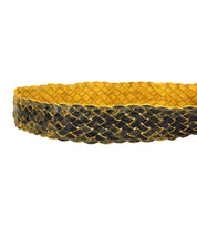 Introducing the Dreamweaver by Bed Stu: a braided belt showcasing a woven pattern of yellow and black hues, highlighted by a round brass-tone buckle for an added touch of vintage allure.