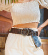 A woman wearing white pants and a Dreamweaver braided belt by Bed Stu.