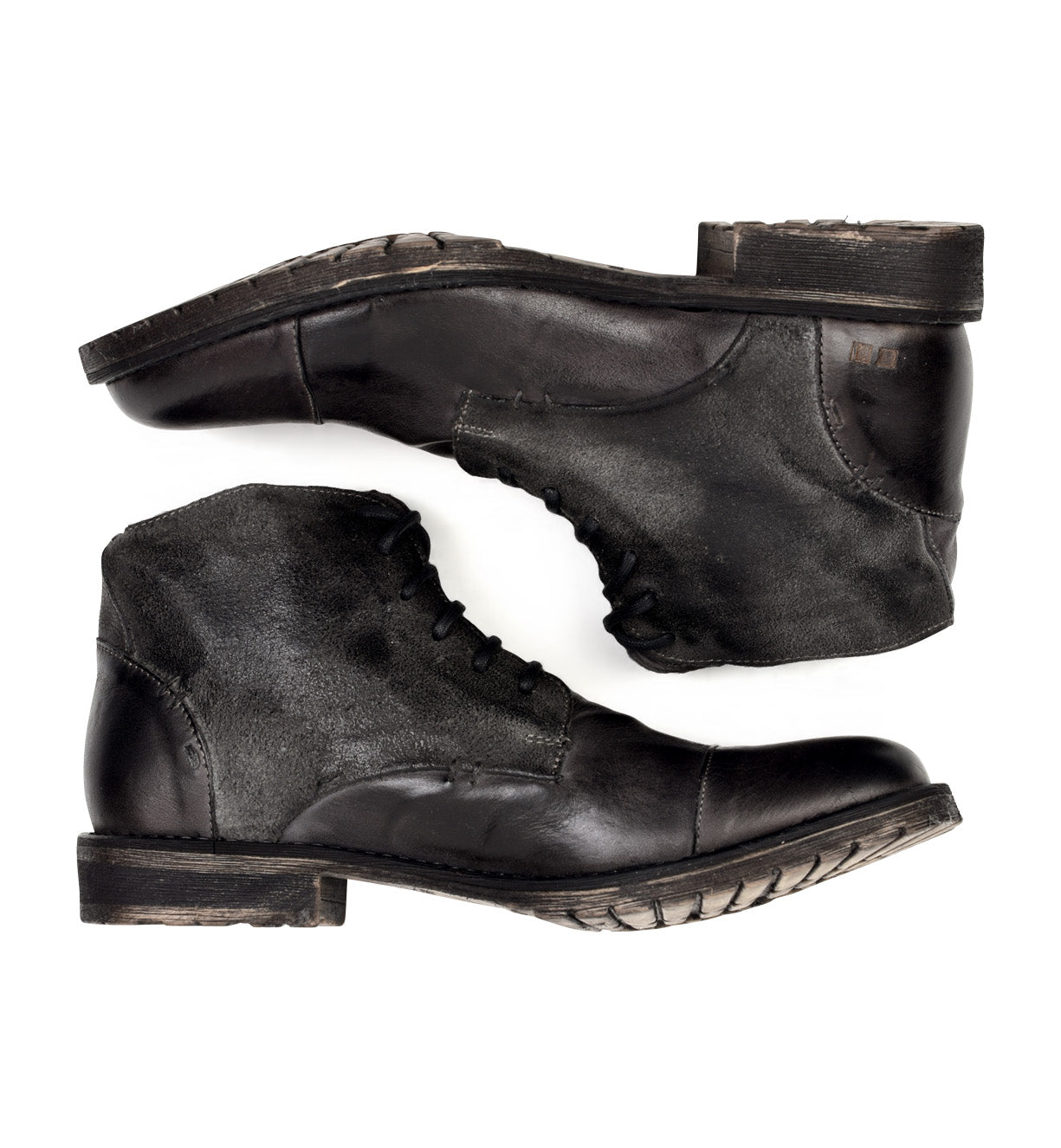 A pair of Dreck black leather boots on a white background by Bed Stu.