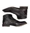 A pair of Dreck black leather boots on a white background by Bed Stu.