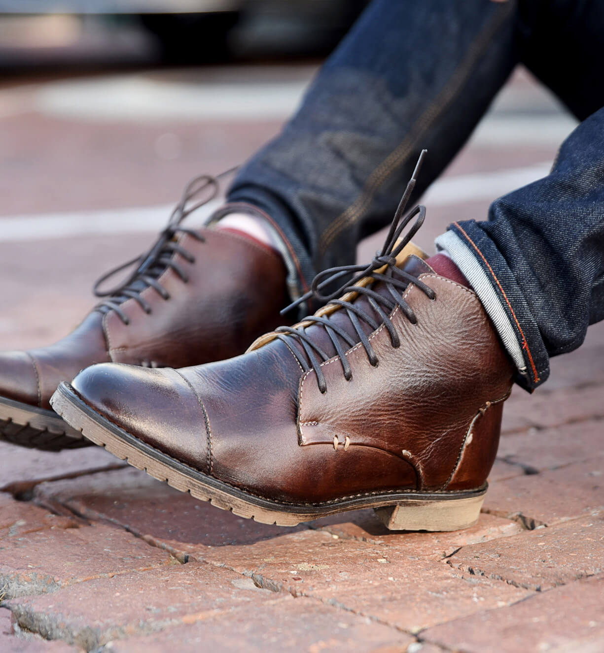 A man wearing a pair of Bed Stu Dreck brown leather boots.